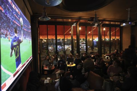 France supporters watch the World Cup semifinal soccer match between France and Morocco, being shown live on television in a bar, in Paris, Wednesday, Dec. 14, 2022. (AP Photo/Aurelien Morissard)