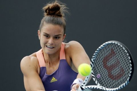 Greece's Maria Sakkari makes a backhand return to Japan's Nao Hibino during their second round singles match at the Australian Open tennis championship in Melbourne, Australia, Wednesday, Jan. 22, 2020. (AP Photo/Andy Wong)