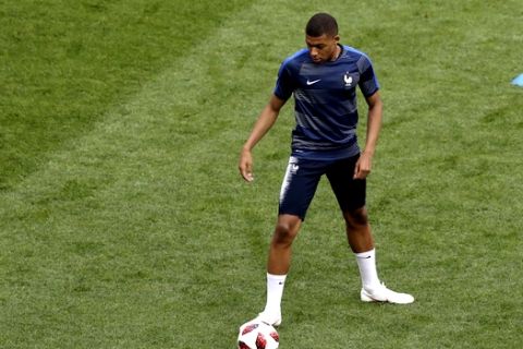 France's Kylian Mbappe exercises during warmup before the final match between France and Croatia at the 2018 soccer World Cup in the Luzhniki Stadium in Moscow, Russia, Sunday, July 15, 2018. (AP Photo/Thanassis Stavrakis)