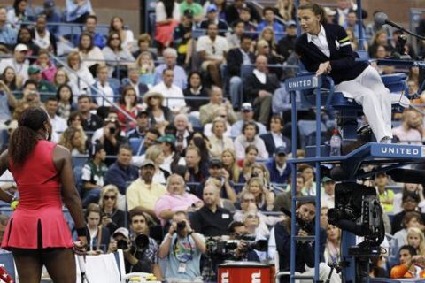 Serena Williams, left, argues with chair umpire Eva Asderaki during the women's championship match against Samantha Stosur of Australia at the U.S. Open tennis tournament in New York, Sunday, Sept. 11, 2011. (AP Photo/Matt Slocum)