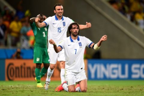 FORTALEZA, BRAZIL - JUNE 24:  Giorgos Samaras and Vasilis Torosidis of Greece celebrate as they are awarded a penalty during the 2014 FIFA World Cup Brazil Group C match between Greece and Cote D'Ivoire at Estadio Castelao on June 24, 2014 in Fortaleza, Brazil.  (Photo by Lars Baron - FIFA/FIFA via Getty Images)