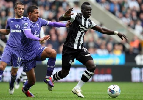 Newcastle United's Cheik Tiote, right, vies for the ball with Tottenham Hotspur's Jake Livermore, left, during their English Premier League soccer match at St James' Park, Newcastle, England, Sunday, Oct. 16, 2011. (AP Photo/Scott Heppell)