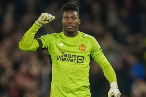 Manchester United's goalkeeper Andre Onana celebrates after Manchester United's Harry Maguire scores his side's opening goal during the Champions League group A soccer match between Manchester United and Copenhagen at the Old Trafford stadium in Manchester, England, Tuesday, Oct. 24, 2023. (AP Photo/Dave Thompson)