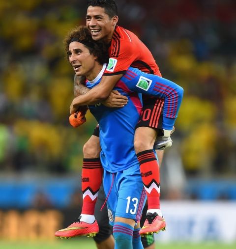 FORTALEZA, BRAZIL - JUNE 17:  Goalkeeper Guillermo Ochoa of Mexico celebrates with Javier Aquino after their 0-0 draw with Brazil during the 2014 FIFA World Cup Brazil Group A match between Brazil and Mexico at Castelao on June 17, 2014 in Fortaleza, Brazil.  (Photo by Laurence Griffiths/Getty Images)