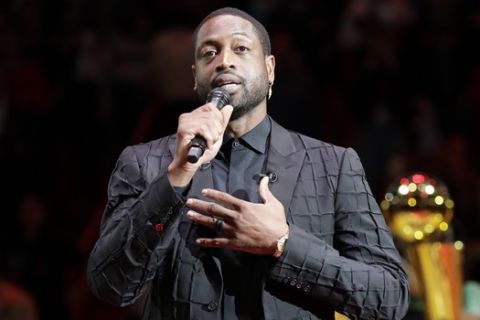 Former Miami Heat guard Dwyane Wade speaks during a jersey retirement ceremony during the halftime of an NBA basketball game between the Miami Heat and the Cleveland Cavaliers, Saturday, Feb. 22, 2020, in Miami. (AP Photo/Wilfredo Lee)