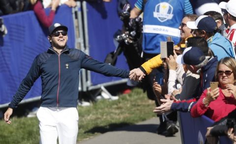 Singer Niall Horan of Europe is greeted by spectators as he arrives at the 1st tee to start the Ryder Cup Celebrity Challenge match at Le Golf National in Saint-Quentin-en-Yvelines, outside Paris, France, Tuesday, Sept. 25, 2018. The 42nd Ryder Cup will be held in France from Sept. 28-30, 2018 at Le Golf National. (AP Photo/Alastair Grant)
