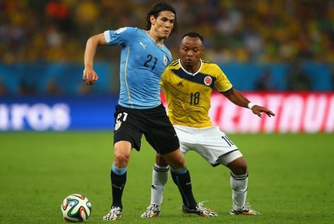 RIO DE JANEIRO, BRAZIL - JUNE 28:  Edinson Cavani of Uruguay and Juan Camilo Zuniga of Colombia compete for the ball during the 2014 FIFA World Cup Brazil round of 16 match between Colombia and Uruguay at Maracana on June 28, 2014 in Rio de Janeiro, Brazil.  (Photo by Clive Rose/Getty Images)
