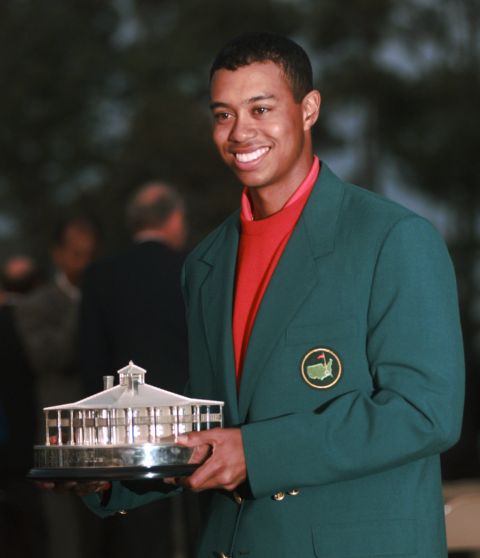 Masters champion Tiger Woods holds a replica of the Masters Trophy after winning the tournament at the Augusta National Golf Club in Augusta, Ga., Sunday, April 13, 1997. (AP Photo/Bill Waugh)