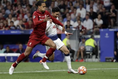Liverpool's Virgil van Dijk, left, fights for the ball with Tottenham's Son Heung-min during the Champions League final soccer match between Tottenham Hotspur and Liverpool at the Wanda Metropolitano Stadium in Madrid, Saturday, June 1, 2019. (AP Photo/Felipe Dana)