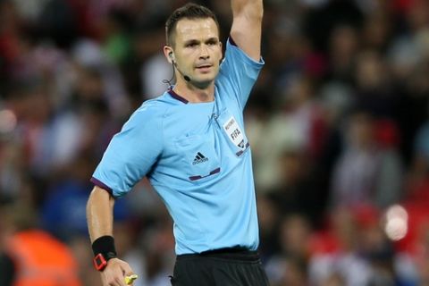 Referee Ivan Kruzliak of Slovakia officiates in the World Cup qualifier group H soccer match between England and Moldova at Wembley Stadium in London, Friday, Sept. 6, 2013. (AP Photo/Alastair Grant)
