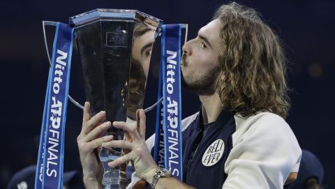 Stefanos Tsitsipas of Greece kisses the and holds up the trophy and celebrates after defeating Austria's Dominic Thiem in the final of the ATP World Finals tennis match at the O2 arena in London, Sunday, Nov. 17, 2019.(AP Photo/Kirsty Wigglesworth)