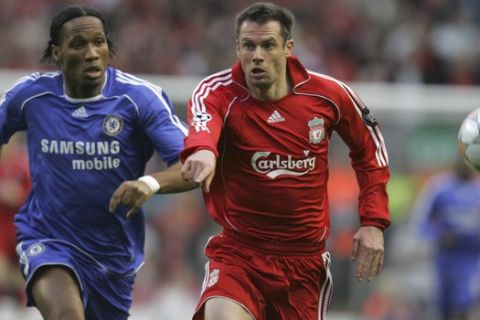 Liverpool's Jamie Carragher, right challenges for the ball with Chelsea's Didier Drogba during their Champions League semifinal first leg soccer match at Liverpool's Anfield ground in Liverpool, England, Tuesday, April 22, 2008. (AP Photo/Paul Thomas )