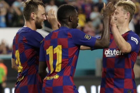 Barcelona's Ivan Rakitic (4) celebrates with Ousmane Dembele (11) and an unidentified teammate after scoring a goal against Napoli during the second half of a soccer match Wednesday, Aug. 7, 2019, in Miami Gardens, Fla. Barcelona won 2-1. (AP Photo/Lynne Sladky)