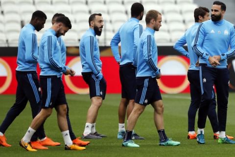 The Olympique Marseille (OM) soccer team with Konstantínos Mítroglou, right, walk, during a training session, at the Groupama stadium in Decines, outside Lyon, central France, Tuesday, May 15, 2018. Marseille will play Atletico Madrid in the Europa League final on Wednesday. (AP Photo/Laurent Cipriani)