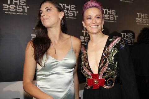 United States forward Megan Rapinoe, right, arrives with Alex Morgan to attend the Best FIFA soccer awards, in Milan's La Scala theater, northern Italy, Monday, Sept. 23, 2019. Netherlands defender Virgil van Dijk is up against five-time winners Cristiano Ronaldo and Lionel Messi for the FIFA best player award and Rapinoe is the favorite for the women's award. (AP Photo/Luca Bruno)