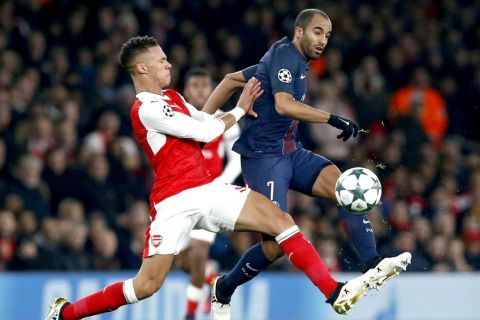 PSG's Lucas, behind, battles for the ball with Arsenal's Kieran Gibbs during the Champions League group A soccer match between Arsenal and Paris Saint Germain at the Emirates stadium in London, Wednesday, Nov. 23, 2016. (AP Photo/Alastair Grant)