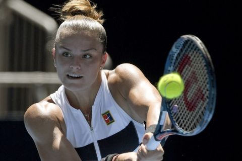 Greece's Maria Sakkari hits a backhand return to Latvia's Jelena Ostapenko during their first round match at the Australian Open tennis championships in Melbourne, Australia, Monday, Jan. 14, 2019. (AP Photo/Andy Brownbill)