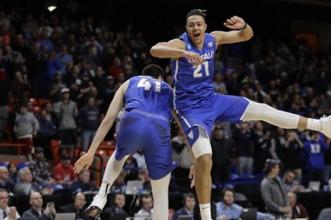 Buffalo's Dominic Johnson, right, and Brock Bertram celebrate after Buffalo upset Arizona 89-68 in first-round game in the NCAA men's college basketball tournament Thursday, March 15, 2018, in Boise, Idaho. (AP Photo/Ted S. Warren)