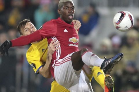 Rostov's Vladimir Granat, left, and Manchester United's Paul Pogba fight for the ball during the Europa League round of 16 first leg soccer match between Rostov and Manchester United in Rostov-on-Don, Russia, Thursday, March 9, 2017. (AP Photo/Denis Tyrin)