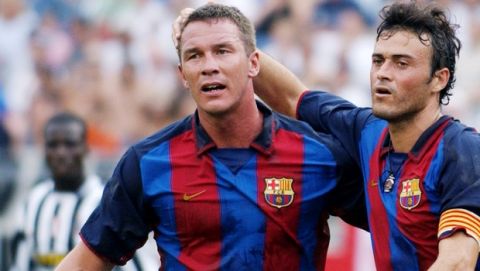 Barcelona's Patrick Andersson, standing left, and Luis Enrique Martinez, center, celebrate a goal in the first half as Juventus' Alessio Tacchinardi sits at left and Nicola Legrottaglie (23) comes up behind, Sunday, July 27, 2003, in Foxboro, Mass. The game ended in a 2-2 tie with  Barcelona beating Juventus 6-5 in an overtime shootout. (AP Photo/Michael Dwyer)