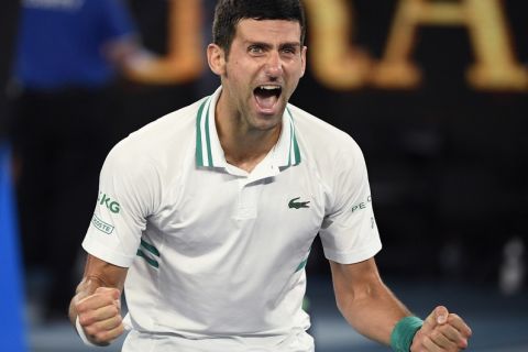 Serbia's Novak Djokovic celebrates after defeating Russia's Daniil Medvedev in the men's singles final at the Australian Open tennis championship in Melbourne, Australia, Sunday, Feb. 21, 2021.(AP Photo/Andy Brownbill)