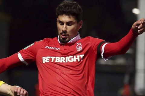 Nottingham Forest's Gil Dias, right and Burton Albion's Jamie Allen battle for the ball, during  the fourth round Football League Cup soccer match between Burton Albion and Nottingham Forest,  at the Pirelli Stadium, in Burton, England, Tuesday, Oct. 30, 2018. (Nigel French/PA via AP)