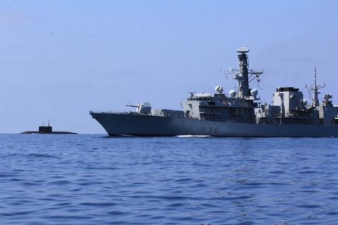 HMS Kent (foreground) monitors Russian sub Stary Oskol as it enters British waters.

MoD handout