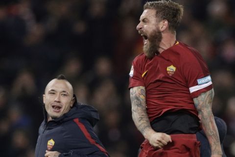 Roma's Daniele De Rossi, right, and Roma's Radia Nainggolan celebrate after beating cross-town rival Lazio 2 - 1 during an Italian Serie A soccer match between AS Roma and Lazio, at the Olympic stadium in Rome, Saturday, Nov. 18, 2017. (AP Photo/Andrew Medichini)