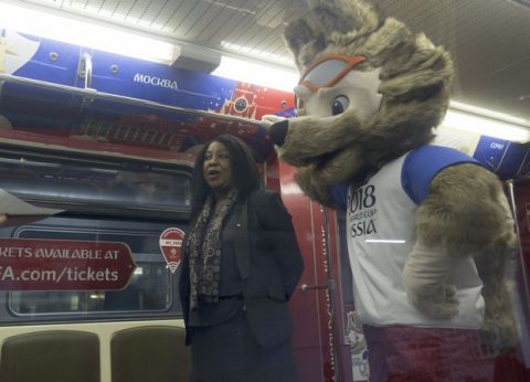 Fatma Samoura, FIFA Secretary General, left, speaks to the media with a mascot of the 2018 World Cup, the wolf named Zabivaka, seen at right, in the metro train branded for the 2018 World Cup during a ceremony in Moscow, Russia, on Tuesday, Nov. 28, 2017. (AP Photo/Ivan Sekretarev)