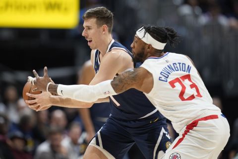 Denver Nuggets forward Vlatko Cancar, left, is defended by Los Angeles Clippers forward Robert Covington during the second half of an NBA basketball game Thursday, Jan. 5, 2023, in Denver. (AP Photo/David Zalubowski)