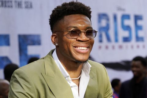NBA basketball player Giannis Antetokounmpo works the press line at the premiere of the Disney+ film "Rise," Wednesday, June 22, 2022, at Walt Disney Studios in Burbank, Calif. The film is based on the story of Antetokounmpo and his family, who emigrated from Nigeria to Greece before Giannis and two of his brothers found success in the National Basketball Association. (AP Photo/Chris Pizzello)