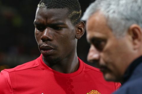 Manchester Uniteds manager José Mourinho, right, with Manchester Uniteds Paul Pogba just prior to the start of Europa League group A soccer match between Manchester United and Zorya Luhansk at Old Trafford, Manchester, England, Thursday, Sept. 29, 2016. (AP Photo/Dave Thompson)