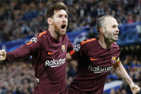 Barcelona's Lionel Messi celebrates with Andres Iniesta scoring his side's first goal during a Champions League round of sixteen first leg soccer match between FC Barcelona and Chelsea at Stamford Bridge stadium in London, Tuesday, Feb. 20, 2018. (AP Photo/Alastair Grant)