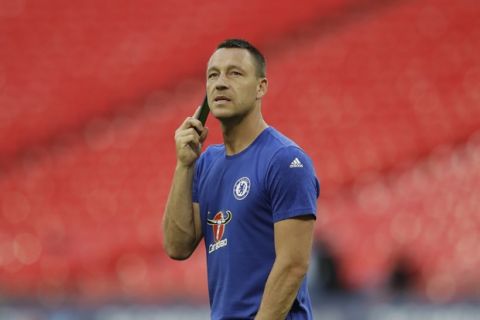 Chelsea's John Terry speaks on the phone walking alone on the pitch after his team lost the English FA Cup final soccer match between Arsenal and Chelsea at the Wembley stadium in London, Saturday, May 27, 2017. (AP Photo/Matt Dunham)