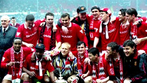 The Manchester United soccer team with the FA Cup after winning the final against Chelsea 4-0 on May 14, 1994, at Wembley Stadium. Players back row, left to right; Roy Keane, Brian McClair, Andrei Kanchelskis, Gary Walsh, Eric Cantona, Steve Bruce, Ryan Giggs and Lee Sharpe. Front row, left to right; Paul Ince, Paul Parker, Peter Schmeichel, Mark Hughes, Denis Irwin, Gary Pallister and Brian Kidd. (AP Photo)
