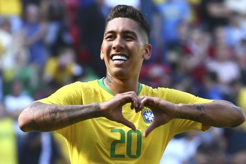 Brazil's Roberto Firmino celebrates after scoring his side's second goal during a friendly soccer match between Brazil and Croatia at Anfield Stadium in Liverpool, England, Sunday, June 3, 2018. (AP Photo/Dave Thompson)