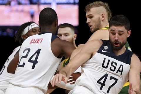 United States' Joe Harris, center, controls the ball during their exhibition basketball game against Australia in Melbourne, Thursday, Aug. 22, 2019. (AP Photo/Andy Brownbill)