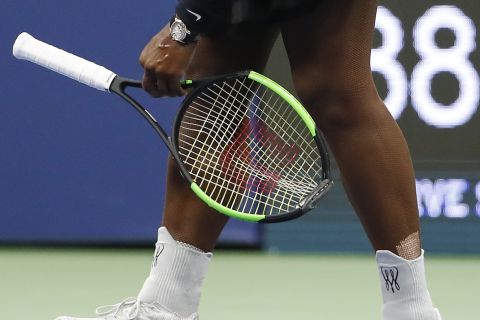 Serena Williams picks up her racket after having her serve broken by Naomi Osaka, of Japan, during the women's final of the U.S. Open tennis tournament, Saturday, Sept. 8, 2018, in New York. (AP Photo/Adam Hunger)