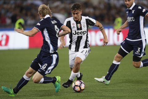 Juventus' Paulo Dybala takes on Lazio's Dusan Basta, left, during the Italian Cup soccer final match between Lazio and Juventus, at Rome's Olympic stadium, Wednesday, May 17, 2017. (AP Photo/Gregorio Borgia)
