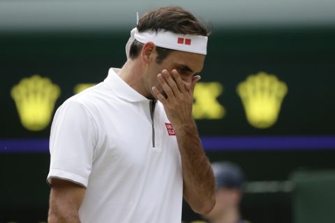 Switzerland's Roger Federer is dejected after losing a point to Japan's Kei Nishikori during a men's quarterfinal match on day nine of the Wimbledon Tennis Championships in London, Wednesday, July 10, 2019. (AP Photo/Tim Ireland)