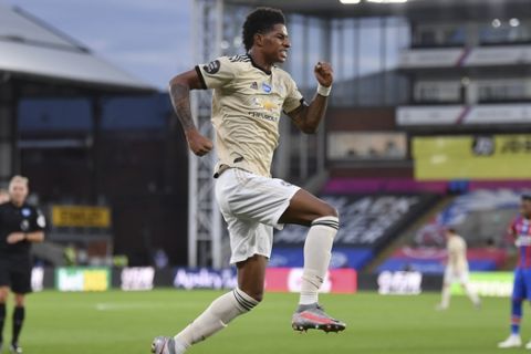 Manchester United's Marcus Rashford celebrates after scoring the opening goal during the English Premier League soccer match between Crystal Palace and Manchester United at Selhurst Park in London, England, Thursday, July 16, 2020. (AP Photo/Justin Setterfield, Pool)