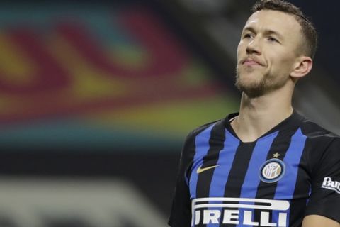 FILE - In this  Saturday, Jan. 19, 2019 file photo, Inter Milan's Ivan Perisic looks up during a Serie A soccer match between Inter Milan and Sassuolo, at the San Siro stadium in Milan, Italy. Inter is firmly in its mid-season slump and failure to win at Parma on Saturday would deepen the Nerazzurri crisis. The players left the field to deafening jeers from their own fans after Sunday's 1-0 defeat at home to relegation-threatened Bologna to pile more pressure on coach Luciano Spalletti, amid speculation the club is preparing to replace him with Antonio Conte. Inter CEO Giuseppe Marotta has denied Spallettis job is at risk but the clubs grip on a Champions League place is weakening. (AP Photo/Luca Bruno, File)