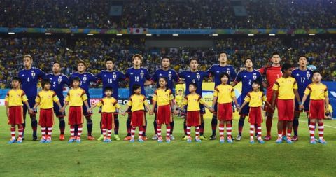 NATAL, BRAZIL - JUNE 19: Japan sing the National Anthem prior to the 2014 FIFA World Cup Brazil Group  C match between Japan and Greece at Estadio das Dunas on June 19, 2014 in Natal, Brazil.  (Photo by Jamie McDonald/Getty Images)