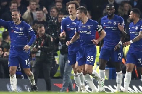 Chelsea's Eden Hazard, left, celebrates after he scores his sides first goal during the English Premier League soccer match between Chelsea and West Ham at Stamford Bridge stadium in London, Monday, April 8, 2019. (AP Photo/Alastair Grant)