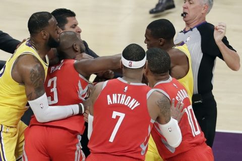 Houston Rockets' Chris Paul, second from left, fights with Los Angeles Lakers' Rajon Rondo, top right, during the second half of an NBA basketball game Saturday, Oct. 20, 2018, in Los Angeles. (AP Photo/Marcio Jose Sanchez)