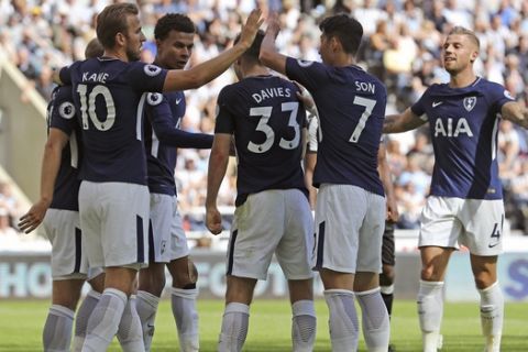 Tottenham Hotspur's Ben Davies, centre, celebrates scoring his side's second goal of the game with team mates during the Premier League soccer match against Newcastle at St James' Park in Newcastle, England, Sunday Aug. 13, 2017. (Owen Humphreys/PA via AP)