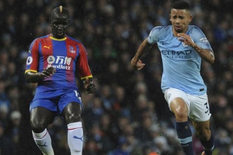 Crystal Palace's Mamadou Sakho, left, and Manchester City's Gabriel Jesus run for the ball during the English Premier League soccer match between Manchester City and Crystal Palace at Etihad stadium in Manchester, England, Saturday, Dec. 22, 2018. (AP Photo/Rui Vieira)