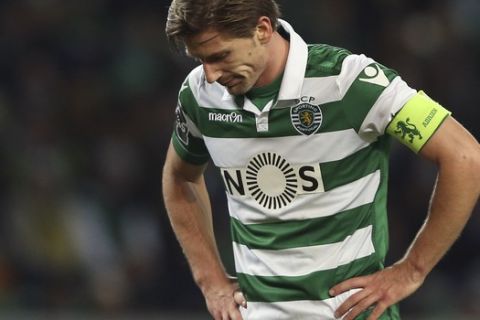 Sportings Adrien Silva, left, reacts during a Portuguese league soccer match against Benfica at the Alvalade Stadium in Lisbon, Saturday, March 5, 2016. Benfica won 1-0 and is now the League leader. (AP Photo/Steven Governo)