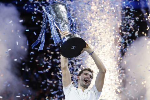 Grigor Dimitrov of Bulgaria lifts the trophy after beating David Goffin of Belgium in their ATP World Tour Finals singles final tennis match at the O2 Arena in London, Sunday Nov. 19, 2017. (AP Photo/Tim Ireland)