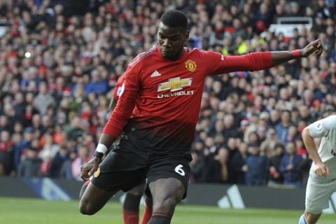 Manchester United's Paul Pogba scores the opening goal from the penalty spot during the English Premier League soccer match between Manchester United and West Ham United at Old Trafford in Manchester, England, Saturday, April 13, 2019. (AP Photo/Rui Vieira)